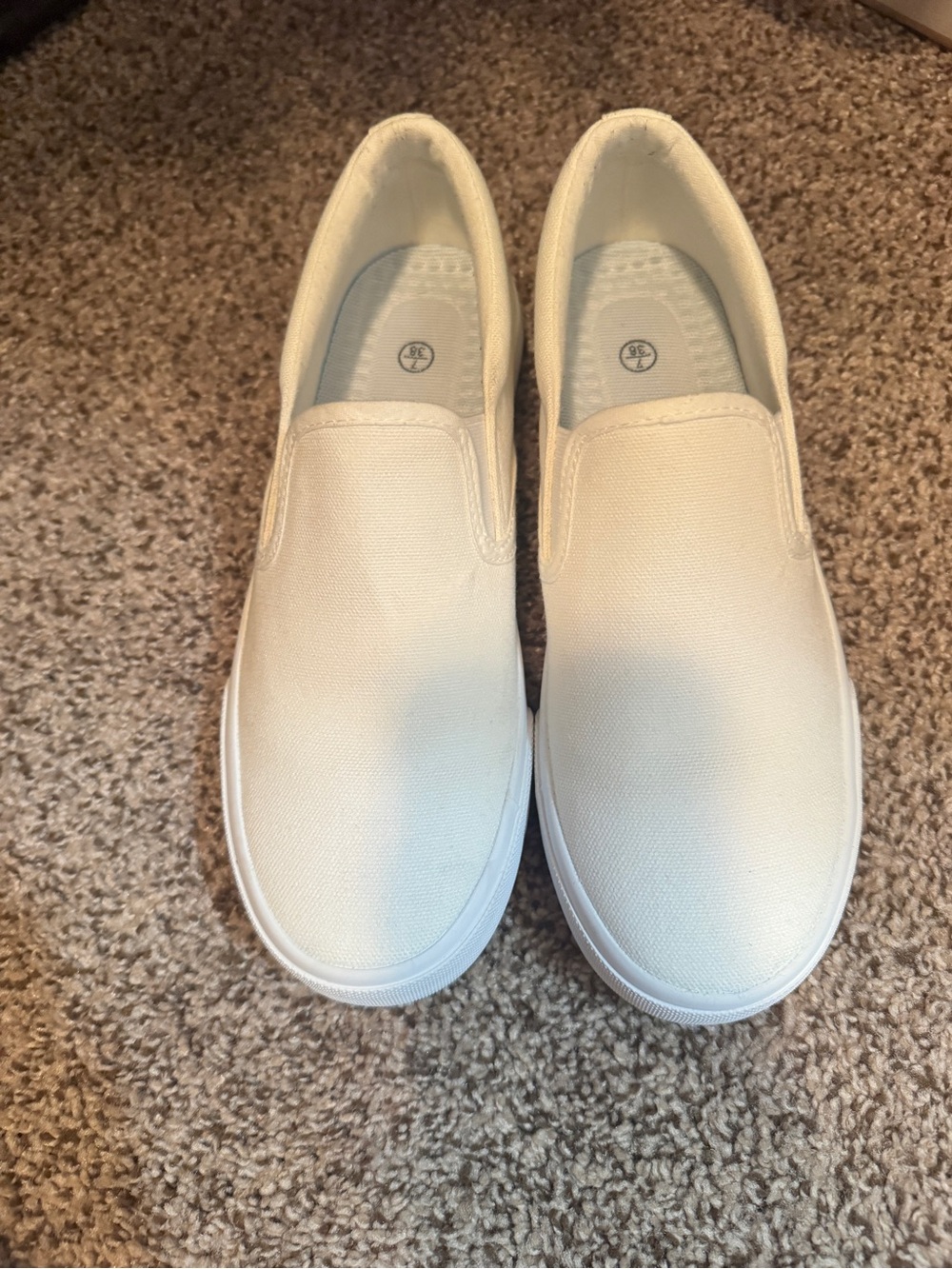 Womenโs Slip-On Canvas Sneakers in White